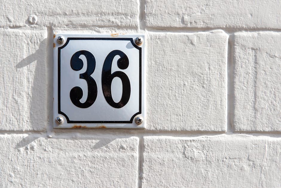 Modern white brick wall with number 36